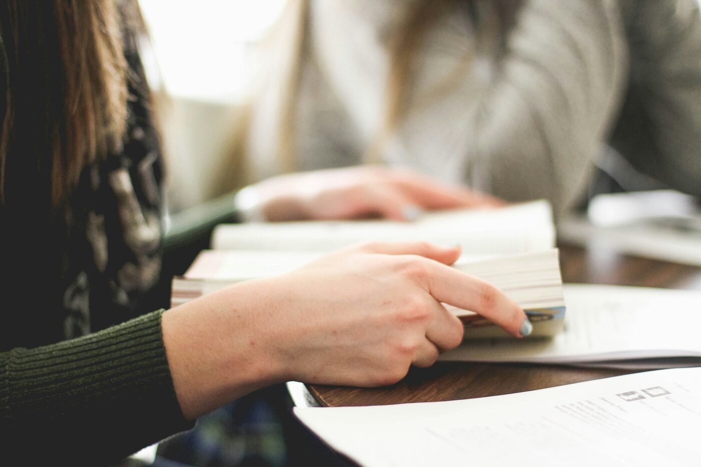 Two people reading Scripture together at a table